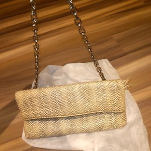 Authentic Cole Haan fold over handbag and clutch